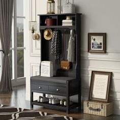 a room with a black cabinet and pictures on the wall next to an open door