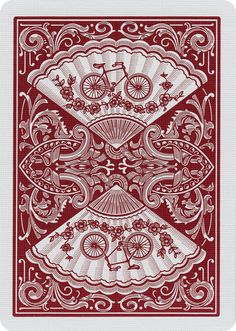 a red and white playing card with an image of a bicycle on the back side