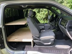 the interior of a green van with open shelves