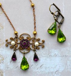 "VINTAGE ELEMENTS Unique Jewellery, Handmade from Vintage Inspired , Original Designs Suffragette, Edwardian, Victorian, Art Nouveau, style antiqued Brass Necklace and Earring Set, with Amethyst and Olivine Peridot  Green Set Glass stones and Crystal Pearl cabochons to complete  the Iconic Suffragette colours; Purple for Loyalty and Dignity, White for Purity and Green for Hope. This necklace has an elegant, fine twisted Bar chain and measures 16 1/2\" (42cm) from end to end plus a 2 1/2\" (6cm) Edwardian Necklace, Cabochon Necklace, Edwardian Jewelry, Vintage Elements, Peridot Green, Jewellery Handmade, Art Nouveau Style, Victorian Art, Brass Necklace