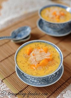 two bowls filled with soup on top of a bamboo mat