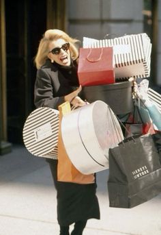 a woman walking down the street carrying shopping bags