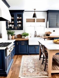 a kitchen with blue cabinets and white counter tops, an area rug on the floor