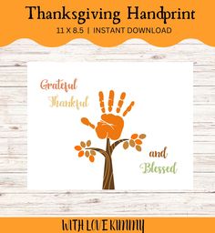 the thanksgiving handprint is shown on top of a wooden table with an orange and green tree