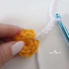 someone is crocheting the end of a piece of yarn to make a flower ornament