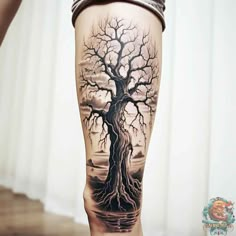 a person with a tree tattoo on their leg