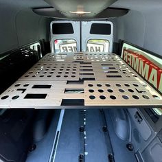 the back end of a van with an aluminum tray on it's cargo area