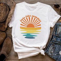 "This colorful retro t-shirt is perfect for summer days or any other day when it feels like summer! The beautiful design with the sunset rays and wavy water draws the eye. The groovy text \"Feels like summer\" above the design adds a playful touch that will bring a smile to everyone's face. The colors make it easy to match with almost every outfit.  Get ready for sunny days with this sunset t-shirt and feel the summer vibes! If you've been looking for a holiday t-shirt for yourself, your wife or best friend, you should get this \"Feel like summer\" tee today!  Bella + Canvas Brand Shirt ▶Unisex Adult Sizing ▶See Our Size Chart For Proper Sizing ▶Rolled sleeves are for styling purposes only ▶Props used in photos are not included with the purchase. ✈ PROCESSING & SHIPPING ✈ Processing Time: Retro T-shirt For Vacation, Summer Multicolor T-shirt With Rainbow Print, Fun Multicolor T-shirt For Summer, Trendy Multicolor T-shirt For Beach, Trendy Multicolor T-shirt For The Beach, Retro Printed Summer T-shirt, Fun Multicolor T-shirt For Vacation, Retro Letter Print T-shirt For Beach Season, Casual Multicolor T-shirt For Beach