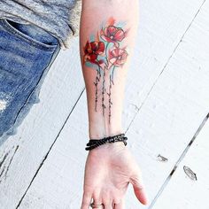 a woman's arm with flowers on it