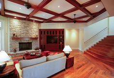 a living room filled with furniture and a fire place next to a stair case in front of a fireplace