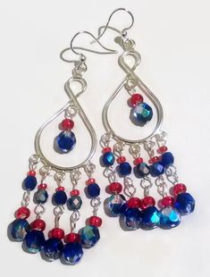 Patriotic Silver Glass  Beaded Red and Blue Fire Czech Crystal  Dangling Chandelier Earrings Fish Hook Nickel Free Perfect for the 4th of July!! These earrings are big and beautiful, without weighing your ears down! They are nickel-free for your comfort. The variety of bright Fired Blue and Bright Red really catches the eye . These lovely chandelier fish hook earrings are one of a kind! You can pair them with Your little black dress for a big splash of color and flash, or a casual blouse and jeans--these are just plain fun and eye catching to wear! All my earrings https://www.etsy.com/shop/TiazasTreasures?section_id=15266317&ref=shopsection_leftnav_2 Everything Else  https://www.etsy.com/shop/TiazasTreasures?ref=shopsection_shophome_leftnav Colors may not be exact due to difference between Beading Design, Wedding Earrings Chandelier, Blue Chandelier, Jewelry 2023, Patriotic Jewelry, Jewelry Holiday, Earrings Wire, Earring Designs, Patriotic Holidays