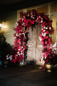 a door is decorated with red and pink flowers