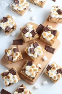 there are many desserts on the cutting board with marshmallows and chocolate