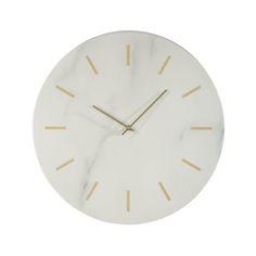 a marble clock with gold hands on a white background