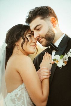 the bride and groom are embracing each other