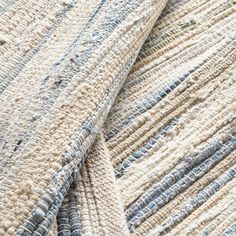 the texture of an upholstered rug with blue and white stripes is shown in closeup