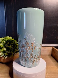 a blue vase sitting on top of a white container