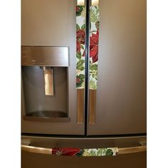 a stainless steel refrigerator with the door ajar and floral design on it's side