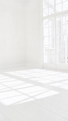 an empty room with white walls and floor