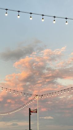 an airplane is flying in the sky with lights strung from it's poles and wires