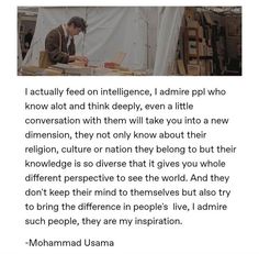 a man sitting at a table in front of a white sheet with words on it