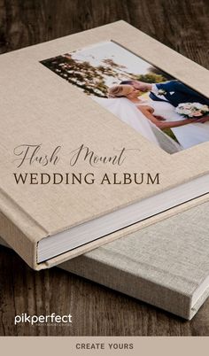 a wedding album is sitting on a wooden table