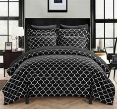 black and white comforter set with matching pillowcases in the middle of a room