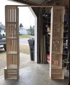 two tall wooden shelves sitting inside of a garage