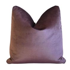 a purple pillow on a white background