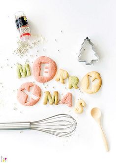 some cookies that are sitting on top of a table next to cookie cutters and utensils