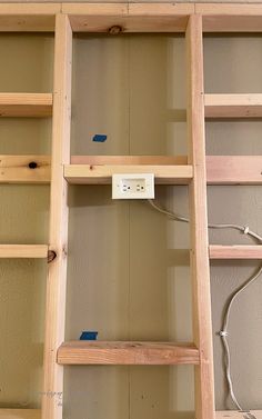 an electrical outlet is plugged into the wall in a room with unfinished shelving