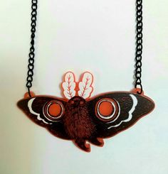 Mothman believes in you! Wear this spooky Northeastern legend around your neck as a reminder of fhd unknown, or just of how cool Mothman is. The light makes the red acrylic kind of glow a bit on a light backdrop! The black coated chain is about 18 inches and the charm is 2 inches. If you know that is too short, let me know and I can add a few inches, but this size fits most necks really well--and you can easily shorten it yourself! My acrylic and wood charms are printed/laser cut by Ink It Labs Red Resin Novelty Jewelry, Novelty Red Resin Jewelry, Red Novelty Plastic Jewelry, Novelty Red Plastic Jewelry, Handmade Black Plastic Jewelry, Handmade Red Halloween Necklaces, Handmade Red Necklaces For Halloween, Black Plastic Jewelry Gift, Red Themed Necklace For Gift