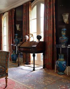 a living room filled with lots of furniture and vases on top of a table