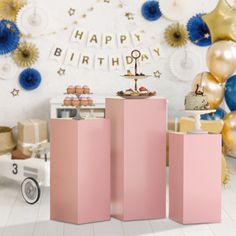 a birthday party with balloons, cake and decorations in pastel pinks and golds