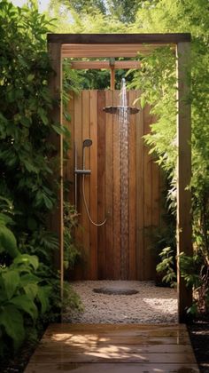 an open shower in the middle of a garden