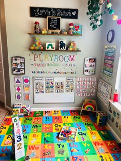 a playroom with colorful tiles and toys on the floor