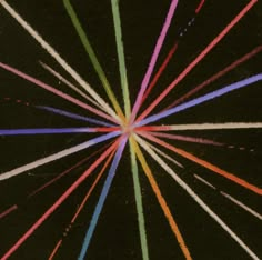 a black background with multicolored lines in the shape of a sunburst