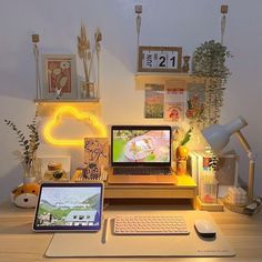 a laptop computer sitting on top of a wooden desk