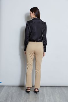 Nothing beats the chic factor and luxe patina of a Silk Satin shirt. Our button-down design features a v-neckline that is perfect for layering under a blazer or wearing on its own- you will live in this shirt all season long. Elie Tahari Exclusive Long Sleeve Silk Satin Button Down shirt 100% Silk Relaxed Fit; Runs true to size. Model is 5'9" and wearing size S Length From Shoulder to Hem: Back 26"L, Sleeve 32.5"L (approx. length for size S) Dry Clean Only Imported Style #: E107G513 Elegant V-neck Top For Business Casual, Elegant Tailored V-neck Top, Chic Business Casual Blouse With Lapel Collar, Luxury Tops With Lapel Collar For Office, Luxury Lapel Collar Tops For Office, Elegant V-neck Top With Button Cuffs, Chic Office Blouse With Lapel Collar, Chic Lapel Collar Tops For Office, Chic Blouse With Lapel Collar For Office