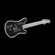 a black and white guitar pin with the words rock n roll is not dead on it