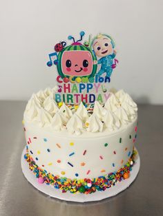 a birthday cake with sprinkles and an image of a cartoon character on top