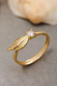 ★14K Solid Gold Angel Wing Ring, 925 Sterling Silver Angel Wing Ring, Cubic Zircon Stone Ring, Dainty Ring, Valentine's Day Gift, Christmas Gift★ ▷ MATERIAL ★ All of our 10K, 14K, 18K Jewelry are Solid Gold. ( Not Gold Filled or Gold Plated ) ★ All of our silver jewelry is 925 sterling silver and 14 carat gold plated. (Our white silver jewelry is rhodium plated.) ▷ PRODUCTION AND PACKAGING ★ Our jewelry is handmade. It is specially prepared for you in the dimensions you want upon order. ★ We work with three colors in our jewelry. Yellow, Rose, White ★ We prepare our jewelry by examining it to the smallest detail with our 21 years of experience. ★ Since we care about customer satisfaction and long-term relationship, we produce our jewelry considering daily use and natural wear. ★ If you wis Angel Wing Jewelry, Hand Jewelry Rings, Wing Ring, Angel Wing Ring, Sterling Silver Skull Rings, Angel Wings Jewelry, Angel Ring, Handmade Gold Ring, Gold Angel Wings