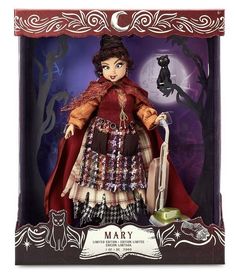 a doll in a box with a black cat on the back and a red cape over her head