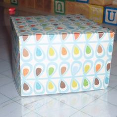 a box sitting on the floor in front of blocks