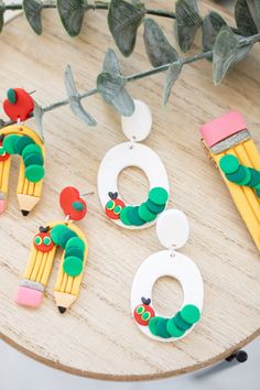 the very hungry caterpillar earrings are on display