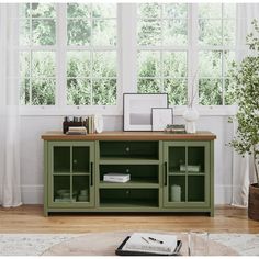 a living room scene with focus on the entertainment center and large window in the background