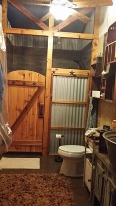 a bathroom with a toilet, sink and shower stall in it's own area