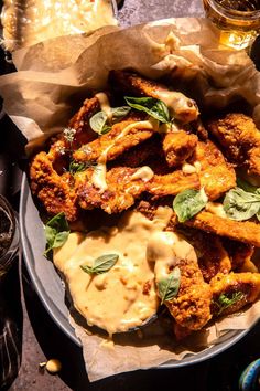 fried chicken with sauce and herbs on a plate