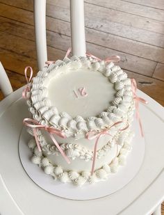 a white cake sitting on top of a wooden table