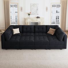 a large black couch sitting in a living room